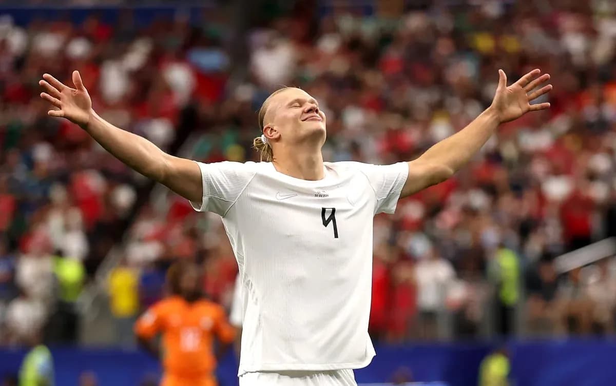Player celebrating with arms raised on the field Player celebrating with arms raised on the field
