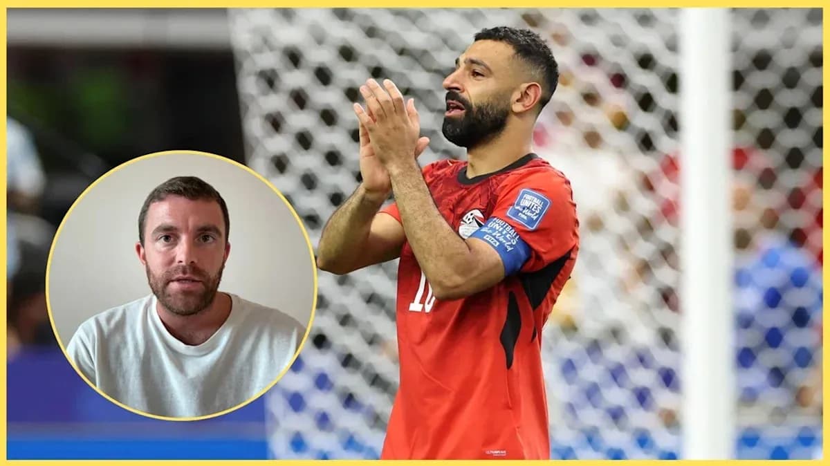 Player in red jersey applauding on the field Player in red jersey applauding on the field