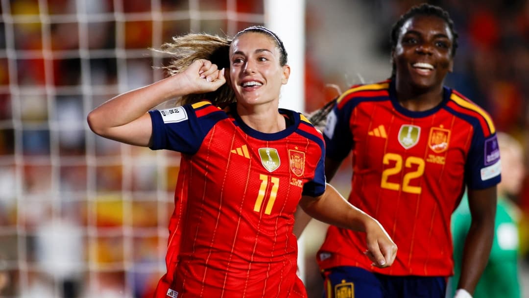 Spanish player celebrating a goal with teammate Spanish player celebrating a goal with teammate