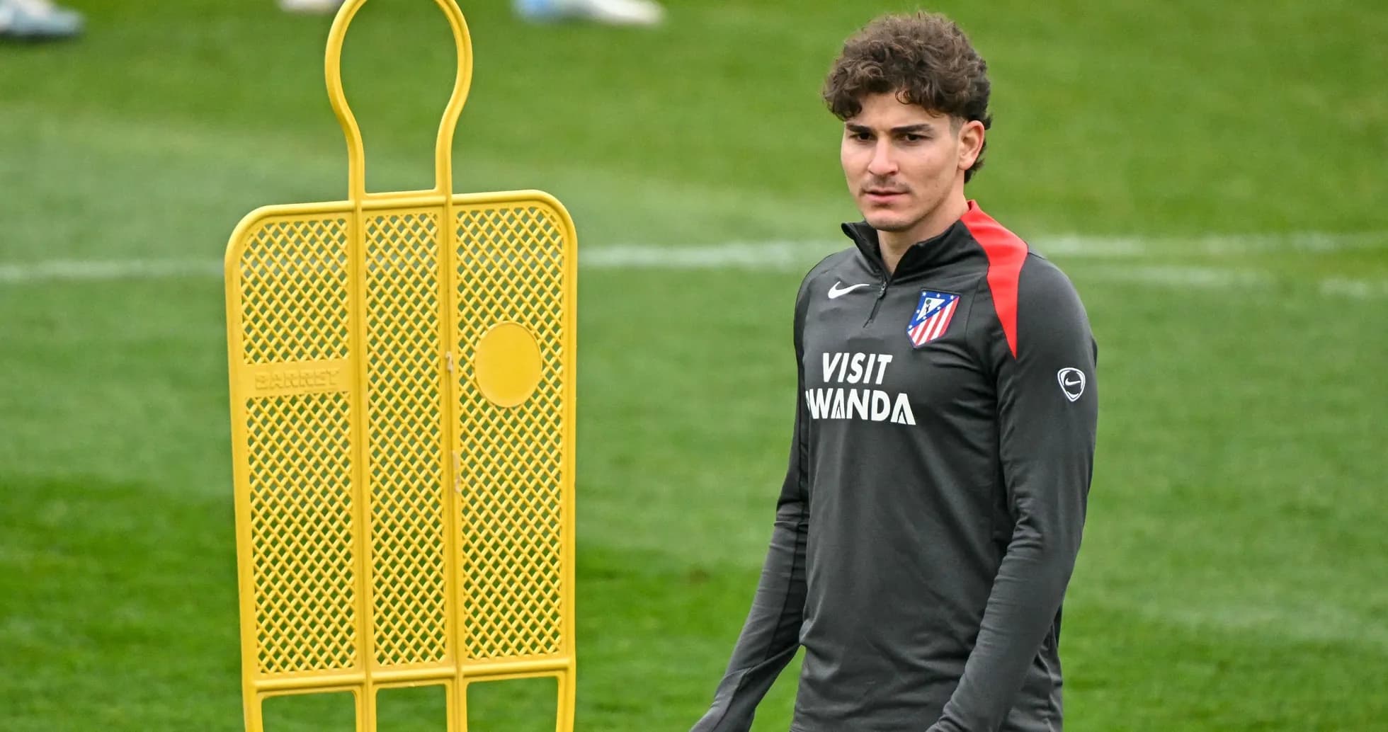 Player in training gear next to a training dummy Player in training gear next to a training dummy