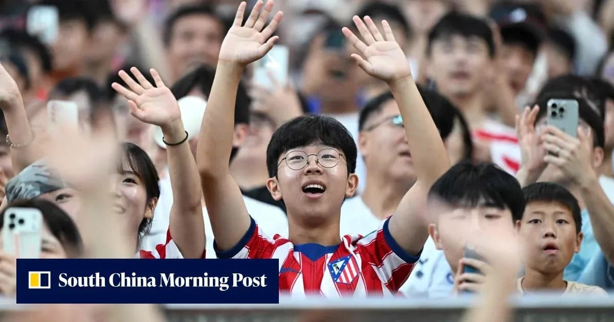 Young fan cheering in Atletico Madrid jersey Young fan cheering in Atletico Madrid jersey