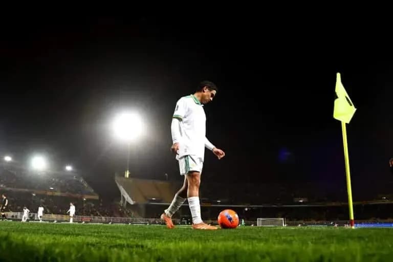 Player preparing to take a corner kick at night Player preparing to take a corner kick at night