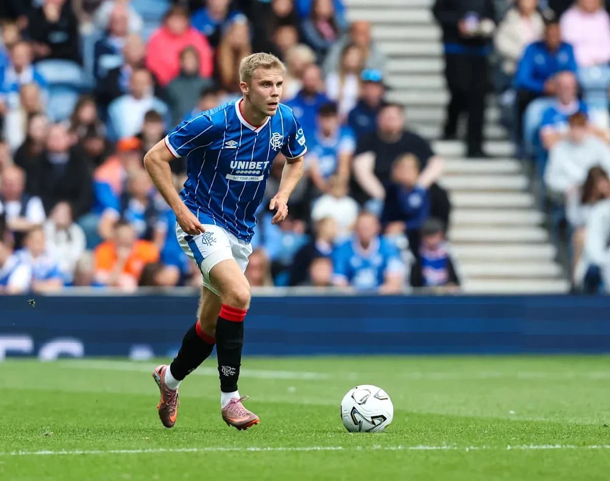 Player in blue kit running with soccer ball Player in blue kit running with soccer ball