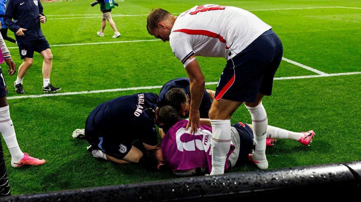 Players attending to an injured teammate on field Players attending to an injured teammate on field