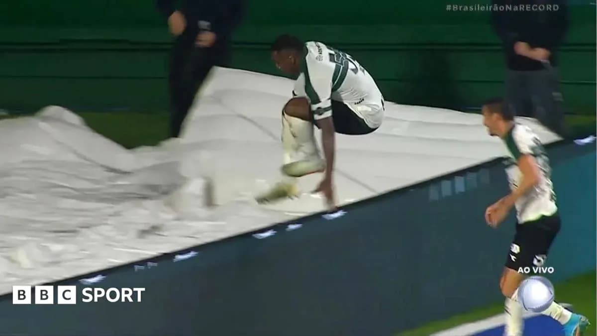Player jumping over a tarpaulin during match Player jumping over a tarpaulin during match