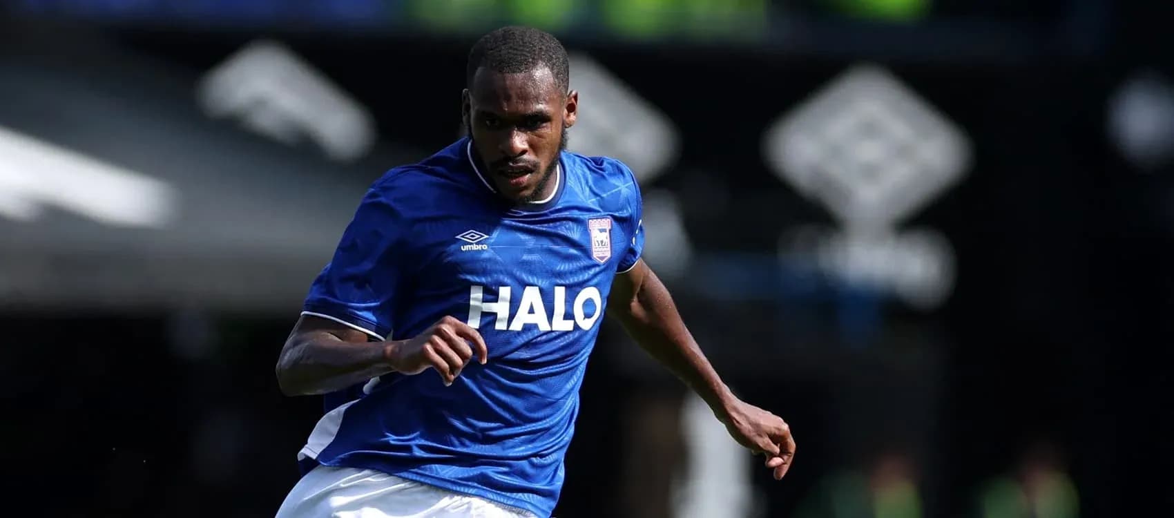 Player in blue jersey running during match Player in blue jersey running during match