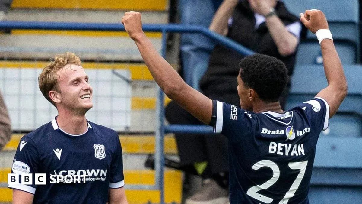 Two players celebrating a goal on the field Two players celebrating a goal on the field