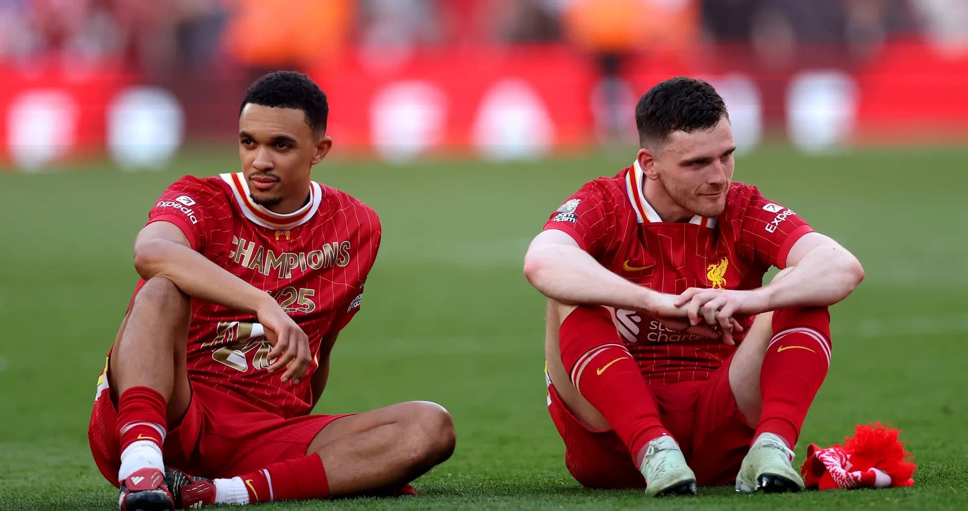 Two Liverpool players seated on the pitch post-match Two Liverpool players seated on the pitch post-match