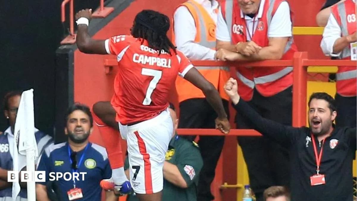 Player celebrating a goal with fans in background Player celebrating a goal with fans in background