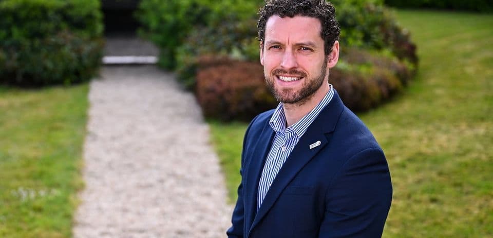 Man in a suit standing on a garden path Man in a suit standing on a garden path
