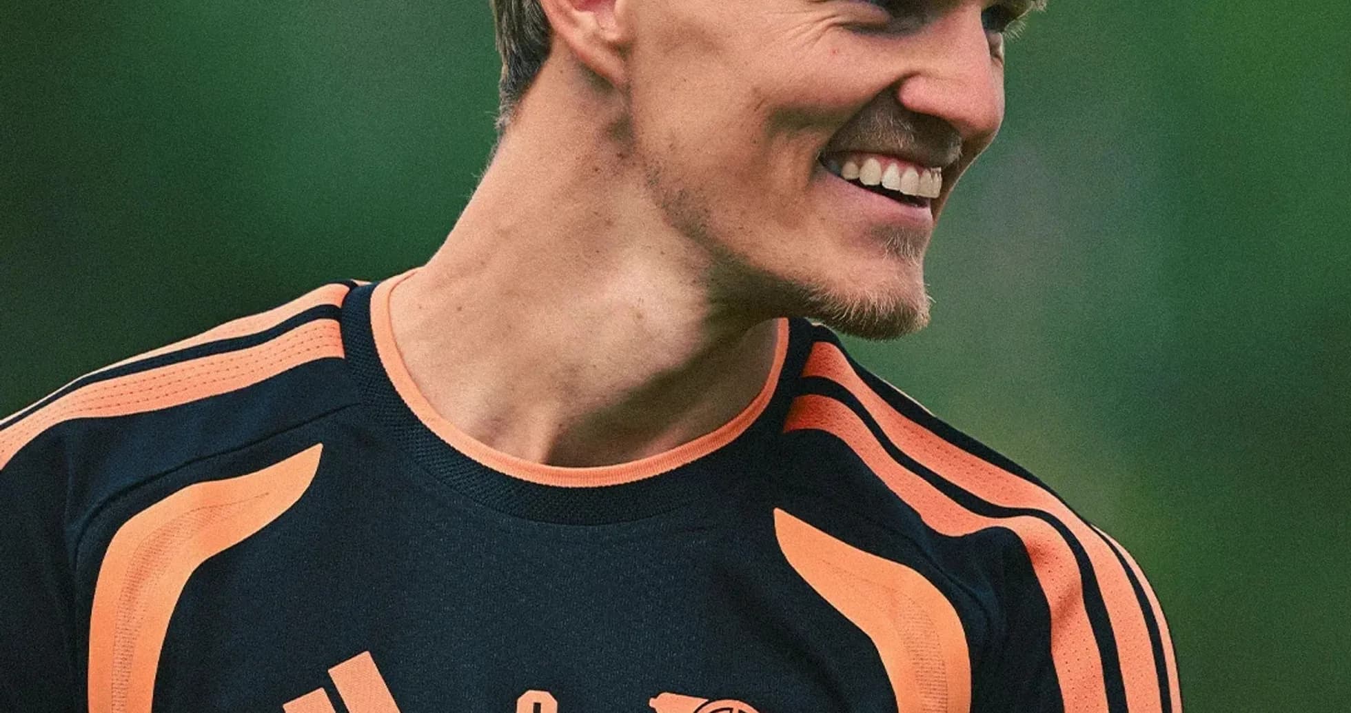 Player smiling in Arsenal training kit outdoors Player smiling in Arsenal training kit outdoors