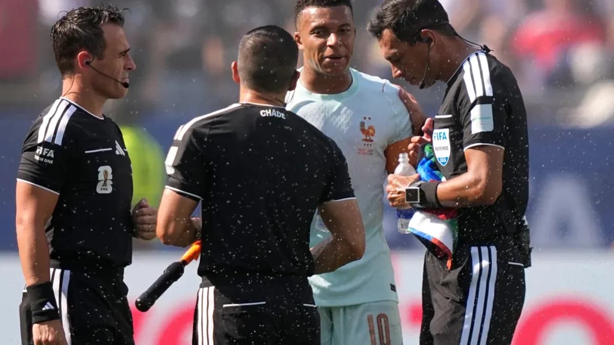 Referees discussing with player during match stoppage Referees discussing with player during match stoppage
