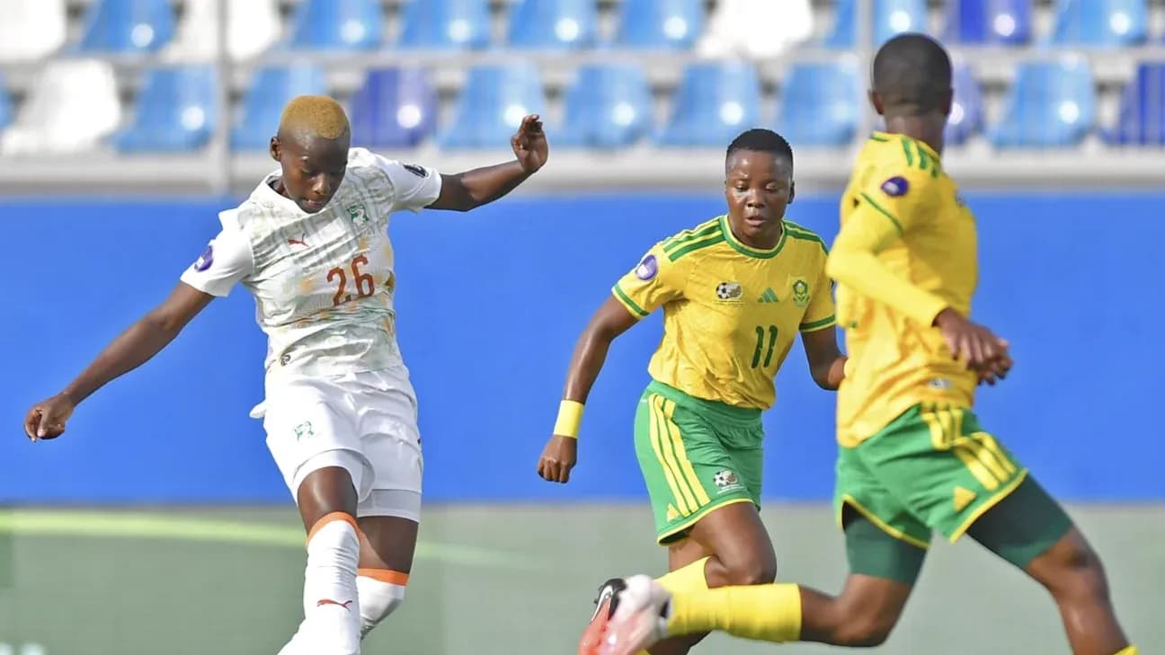 Ivorian player kicking the ball in match action Ivorian player kicking the ball in match action