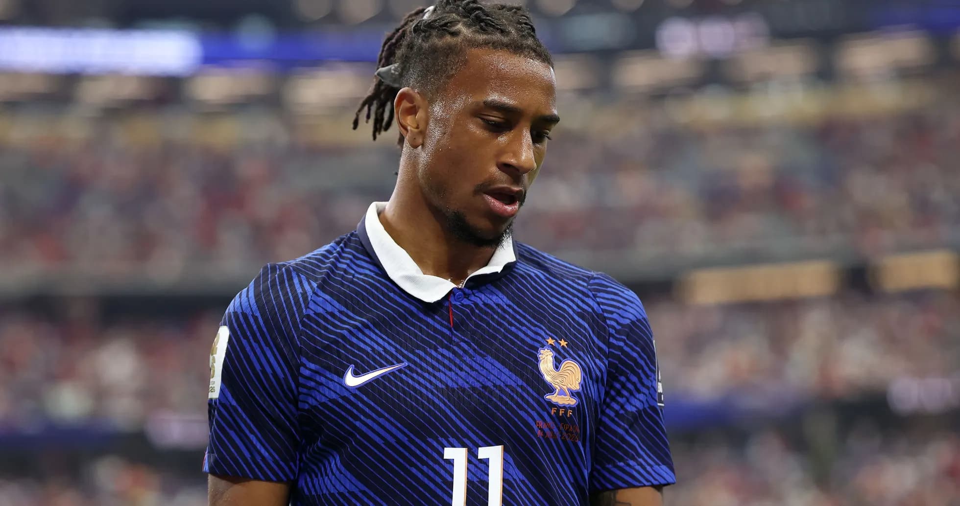 Player in France kit during match, looking down Player in France kit during match, looking down