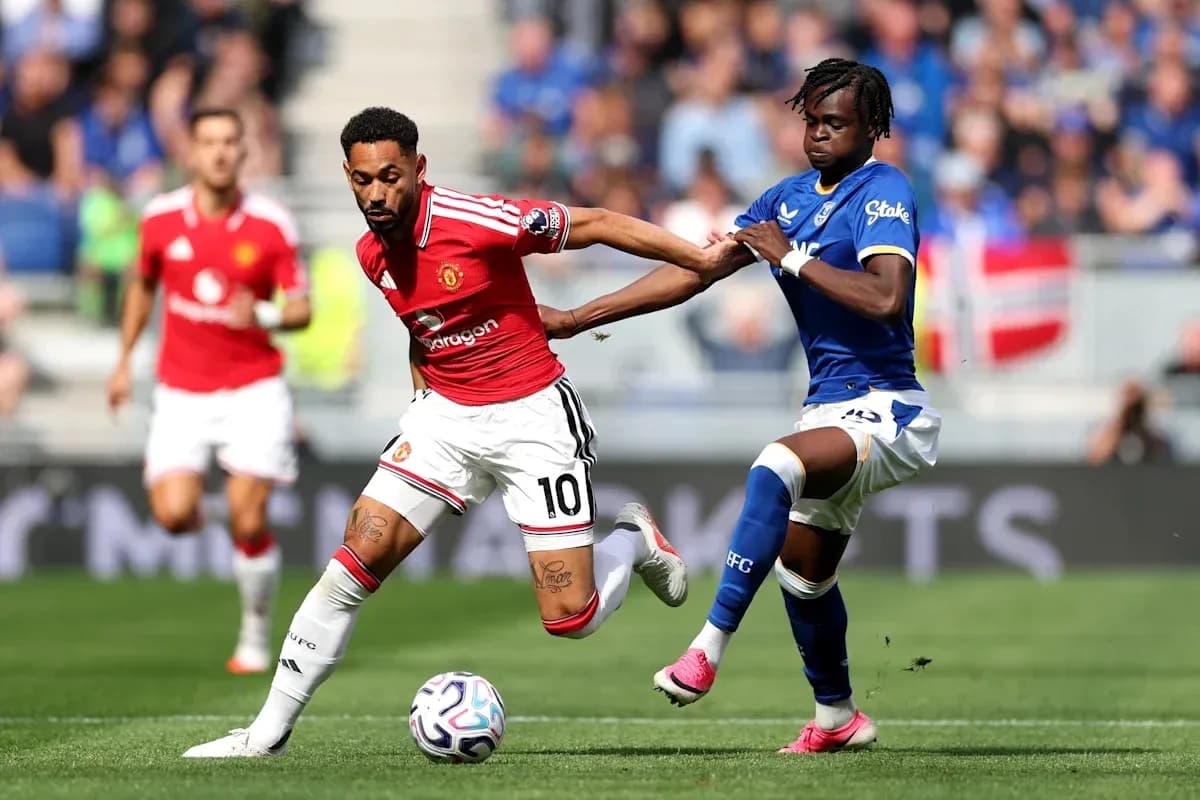 Player dribbling past opponent during football match Player dribbling past opponent during football match