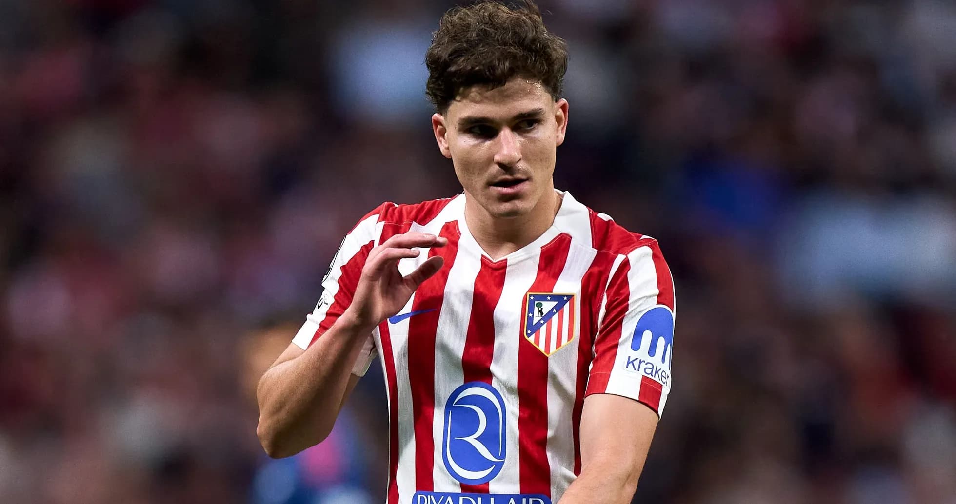 Player in Atlético Madrid jersey gesturing on field Player in Atlético Madrid jersey gesturing on field
