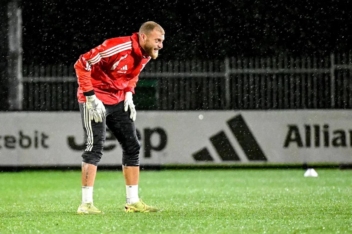 Goalkeeper practicing in the rain during training Goalkeeper practicing in the rain during training