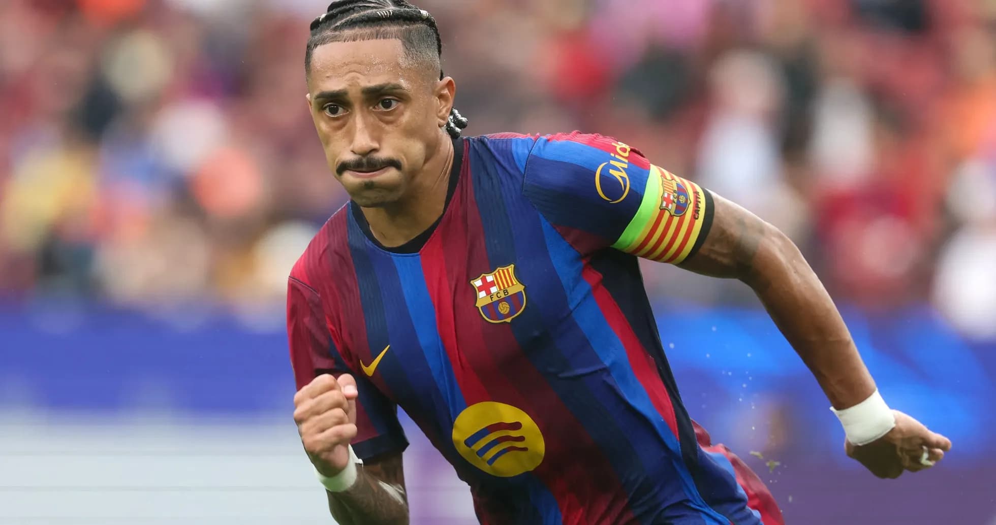 Player running on the pitch wearing Barcelona kit Player running on the pitch wearing Barcelona kit