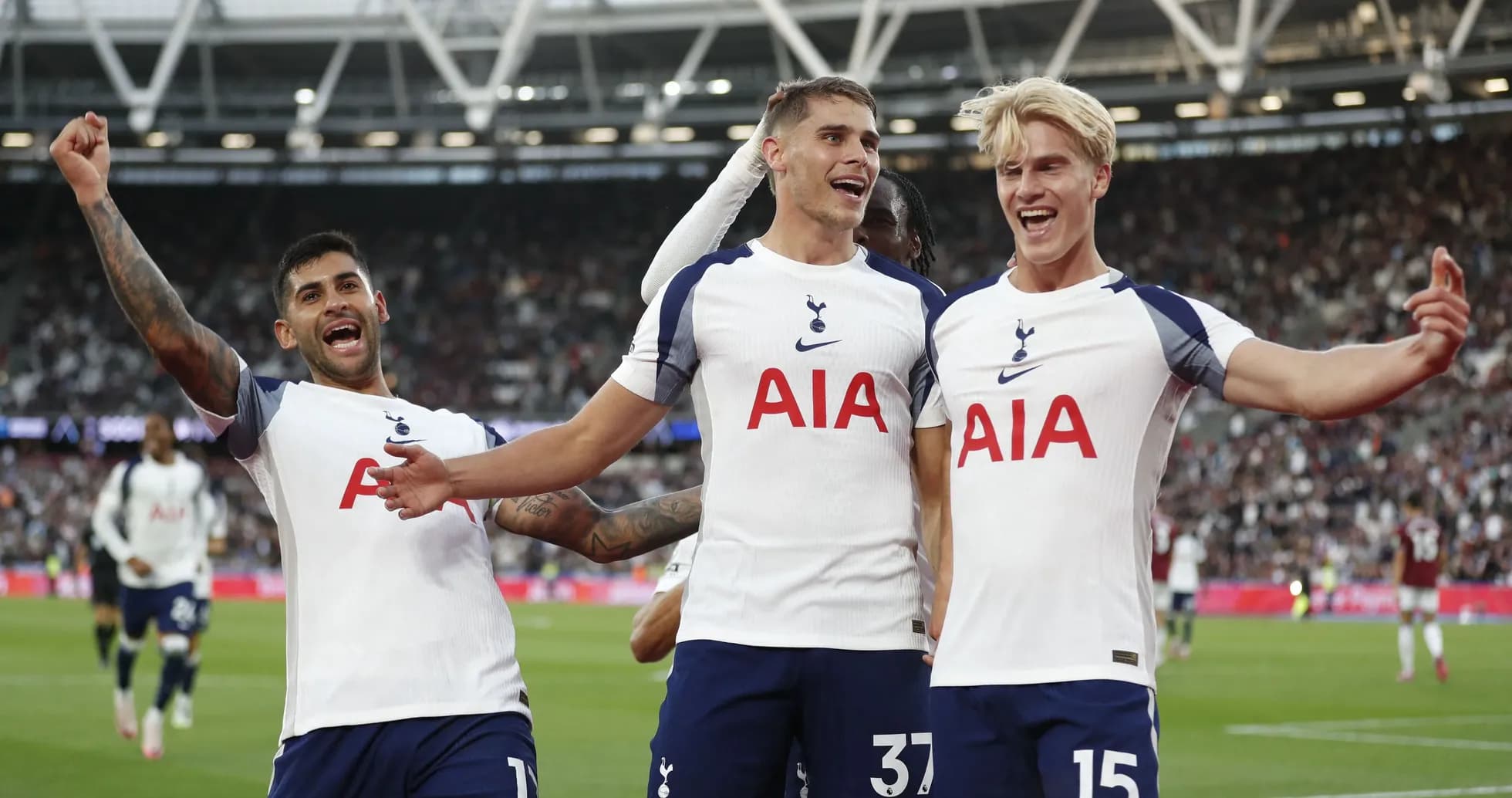 Tottenham players celebrating a goal on the pitch Tottenham players celebrating a goal on the pitch