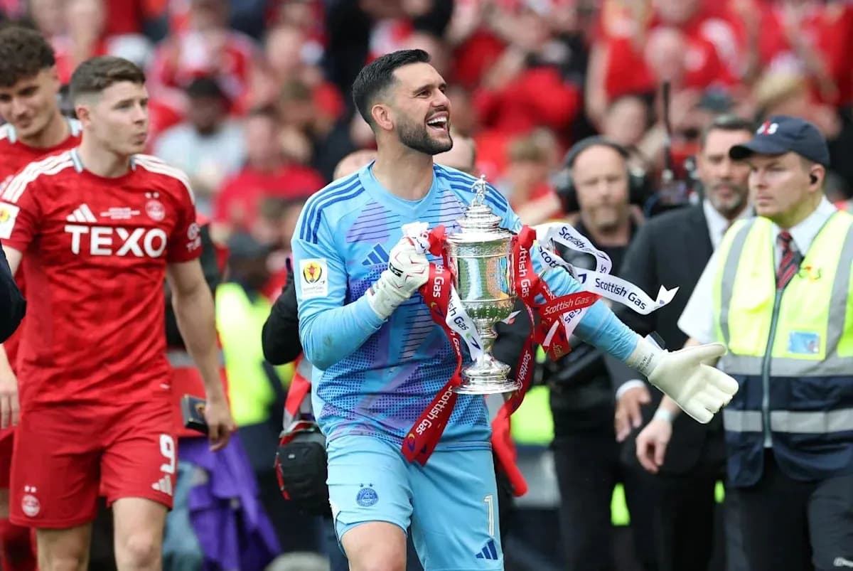 Goalkeeper celebrating with the trophy after match Goalkeeper celebrating with the trophy after match
