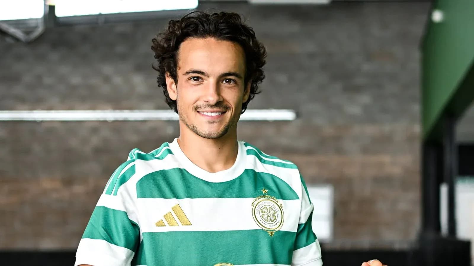 Player wearing green and white striped jersey indoors Player wearing green and white striped jersey indoors