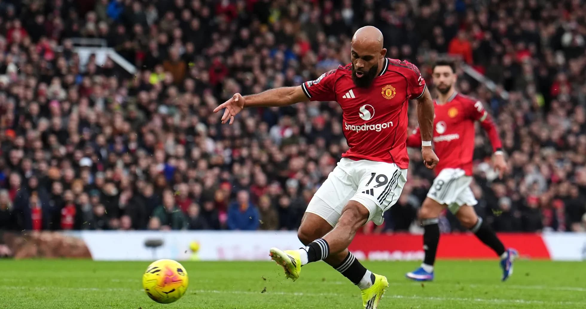Manchester United player taking a shot at goal Manchester United player taking a shot at goal