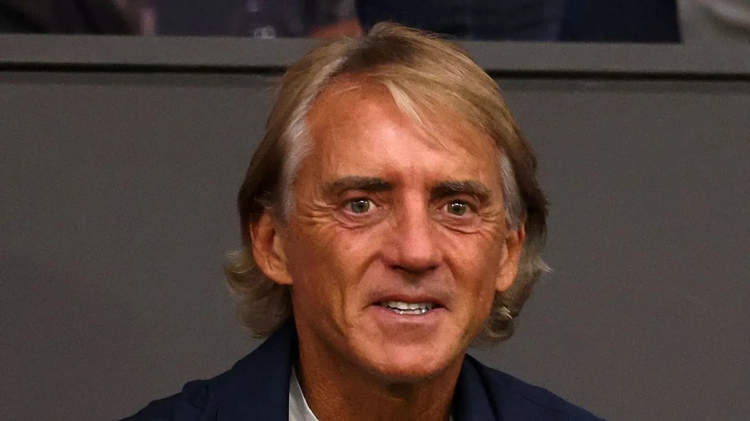 Coach smiling in a stadium setting Coach smiling in a stadium setting