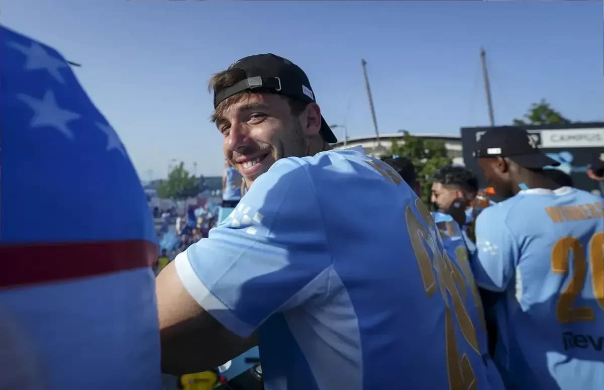Player smiling in team jersey at event Player smiling in team jersey at event