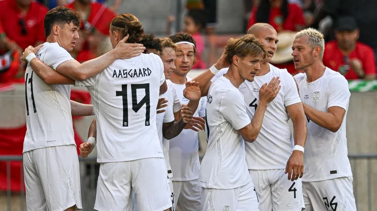 Players celebrating a goal in white jerseys Players celebrating a goal in white jerseys
