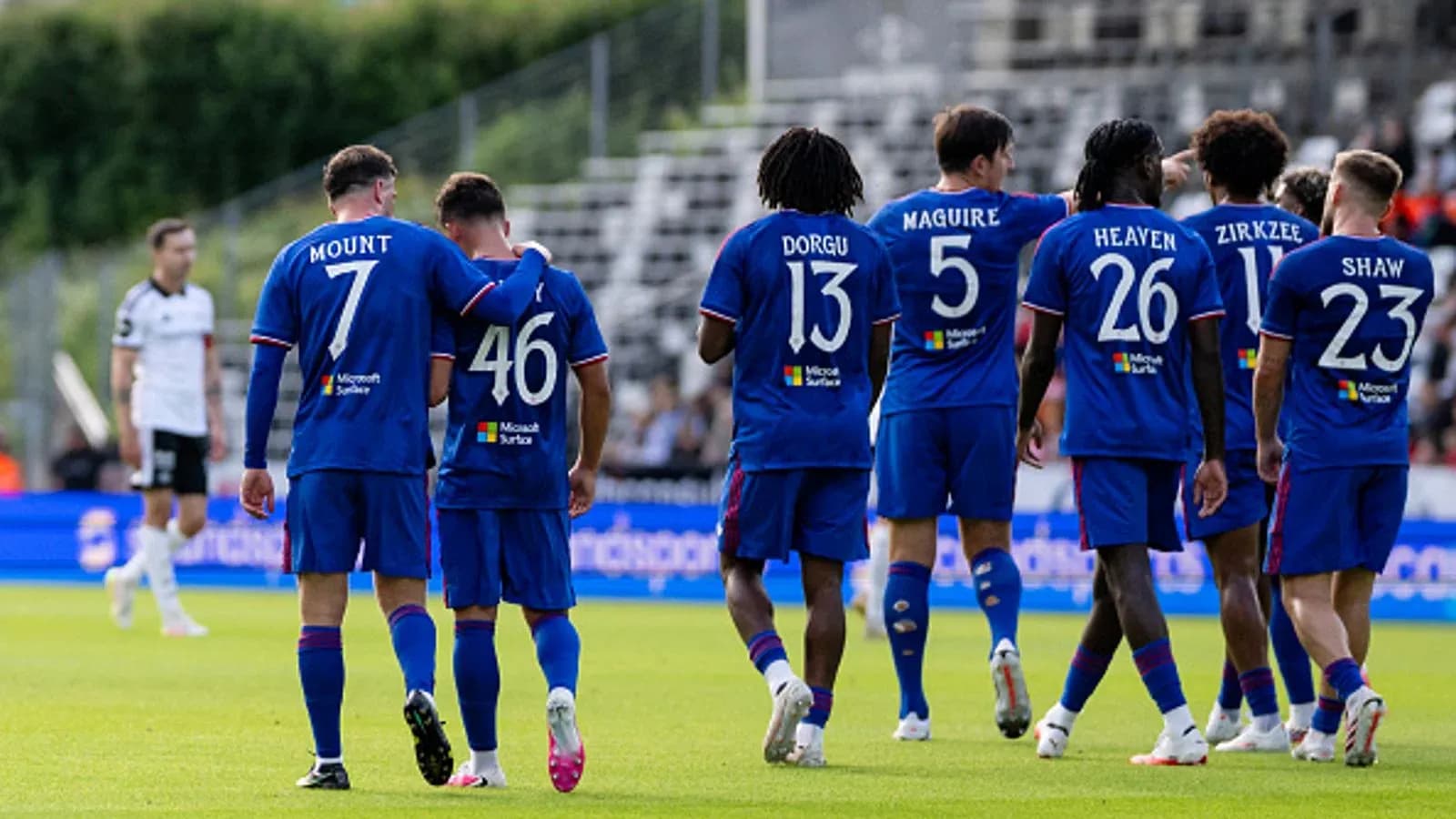 Players in blue jerseys celebrating on the pitch Players in blue jerseys celebrating on the pitch