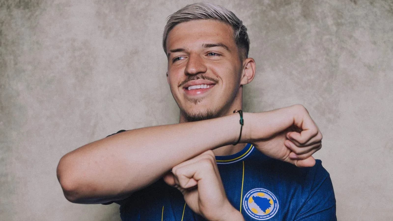 Player smiling while wearing team jersey Player smiling while wearing team jersey