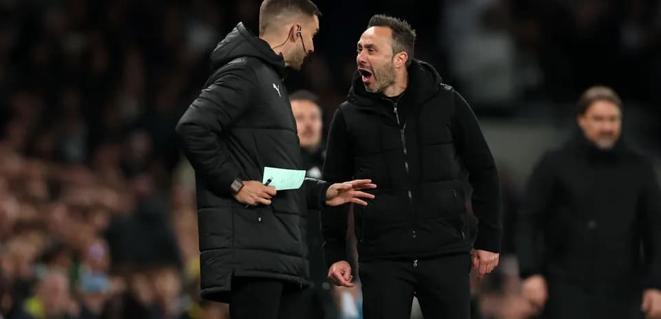 Two coaches discussing during a football match Two coaches discussing during a football match
