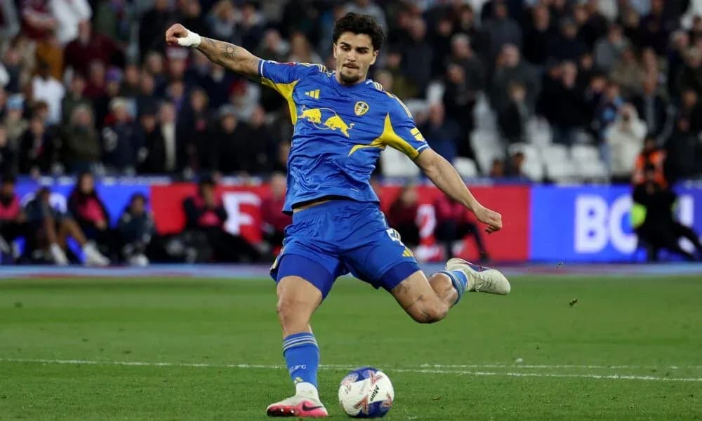 Player kicking ball during a football match Player kicking ball during a football match